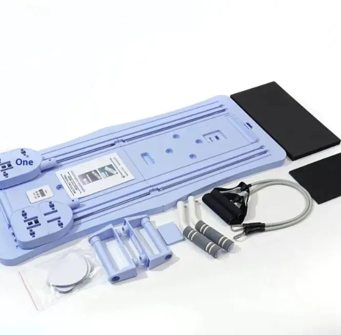 Set of Compact Pilates Sliding Board including a mat, resistance bands, and other fitness tools on a white background.