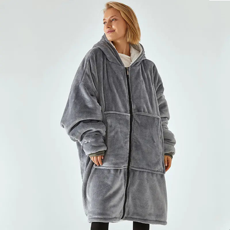 Person wearing a gray fleece robe against a white background