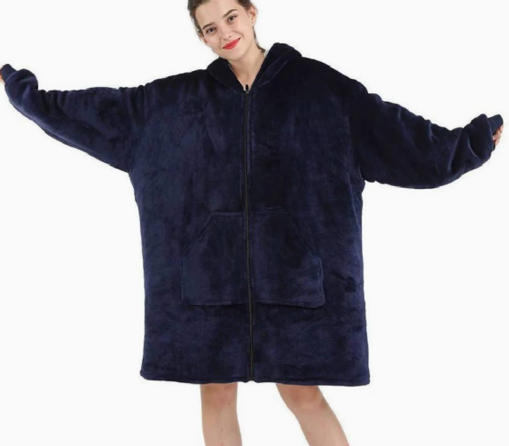 Person wearing a navy blue fleece blanket with a hood on a white background