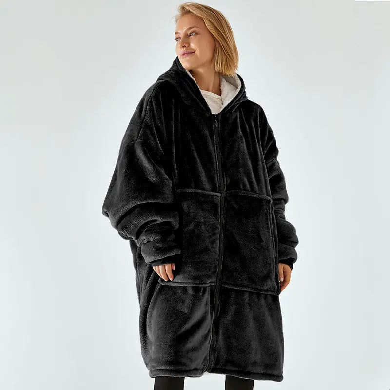 Person wearing a black fleece robe on a light gray background