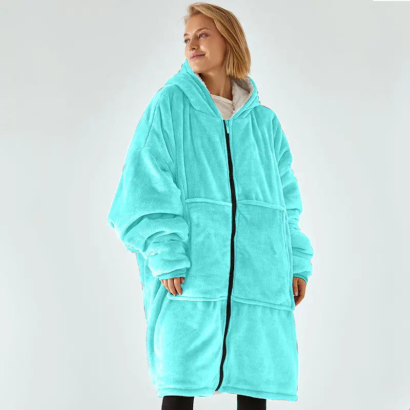 Person wearing a turquoise fleece robe on a white background