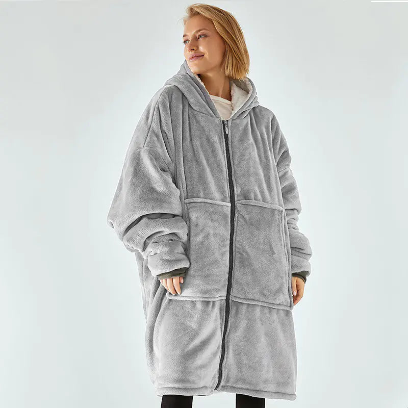Person wearing a gray fleece robe on a white background