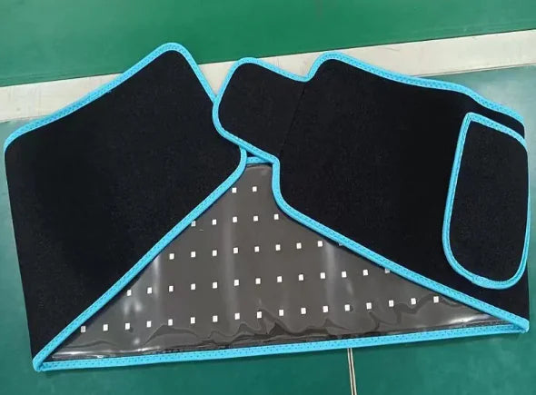 Black LED Infrared Belt Therapy Device with blue trim on a green surface