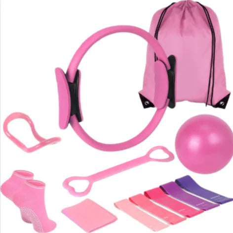 Pink fitness equipment set including resistance bands, ball, and other accessories on a white background