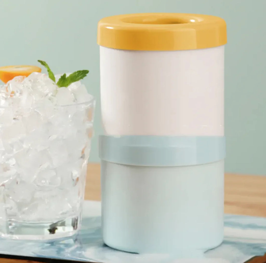 2 Portable 2-in-1 Ice Bucket and Cube Maker stacked on top of each other with a glass of ice and a slice of fruit on a light blue background