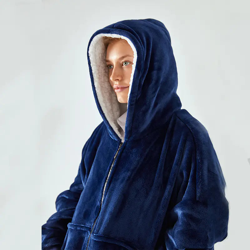 Person wearing a blue hooded robe against a white background